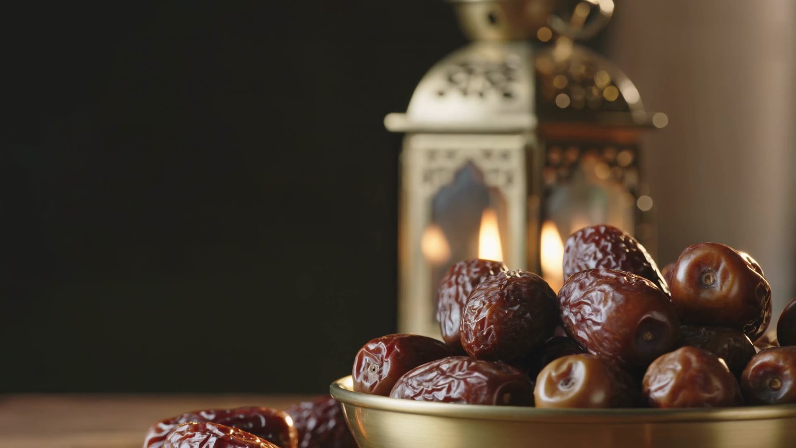 Premium dates in a golden bowl beside glowing Ramadan lanterns